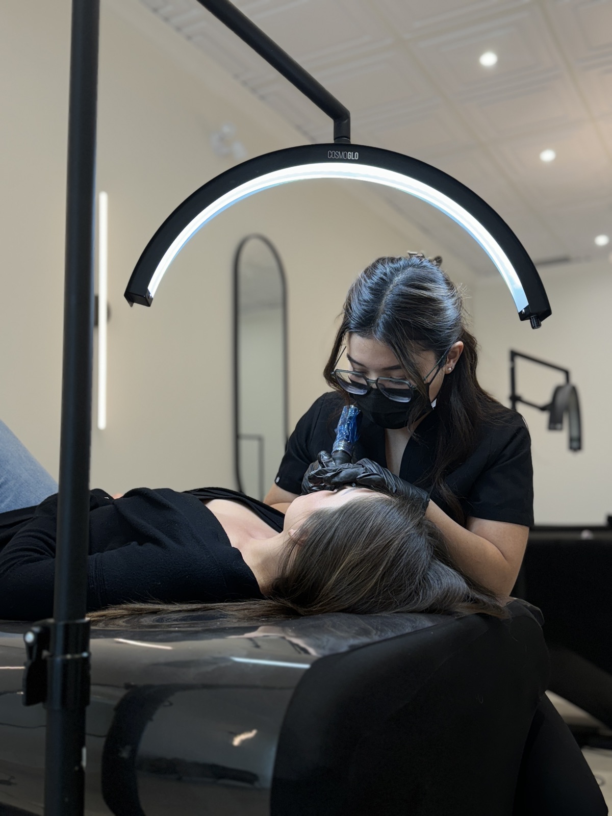 Bao Han performing a cosmetic tattoo treatment in the studio